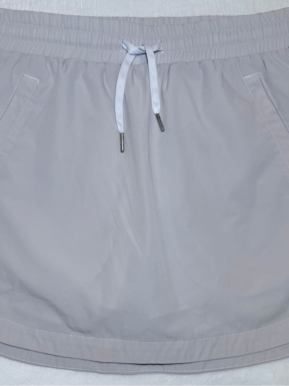 HALARA Women’s High Waisted Drawstring Pocket 2-in-1 Curved Hem Mini Golf Skirt